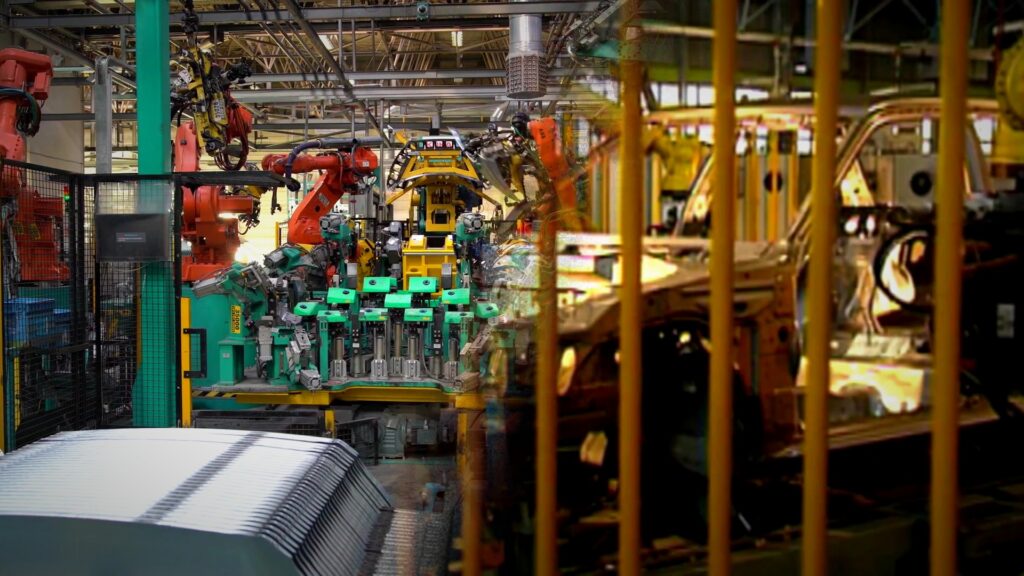 Brazo robótico industrial de gran tamaño levanta un automóvil en una feria en Shanghái